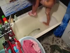 A slender, shameless woman enjoys masturbating in the shower.
